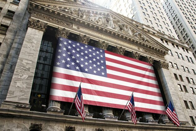 realistic-logo-banner-flag-on-NYSE-pillars-new-york-stock-exchange-flag-free-mockup-generator-psd-template-3-